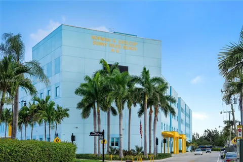 a palm tree sitting in front of a building