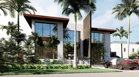 a couple of palm trees in front of house