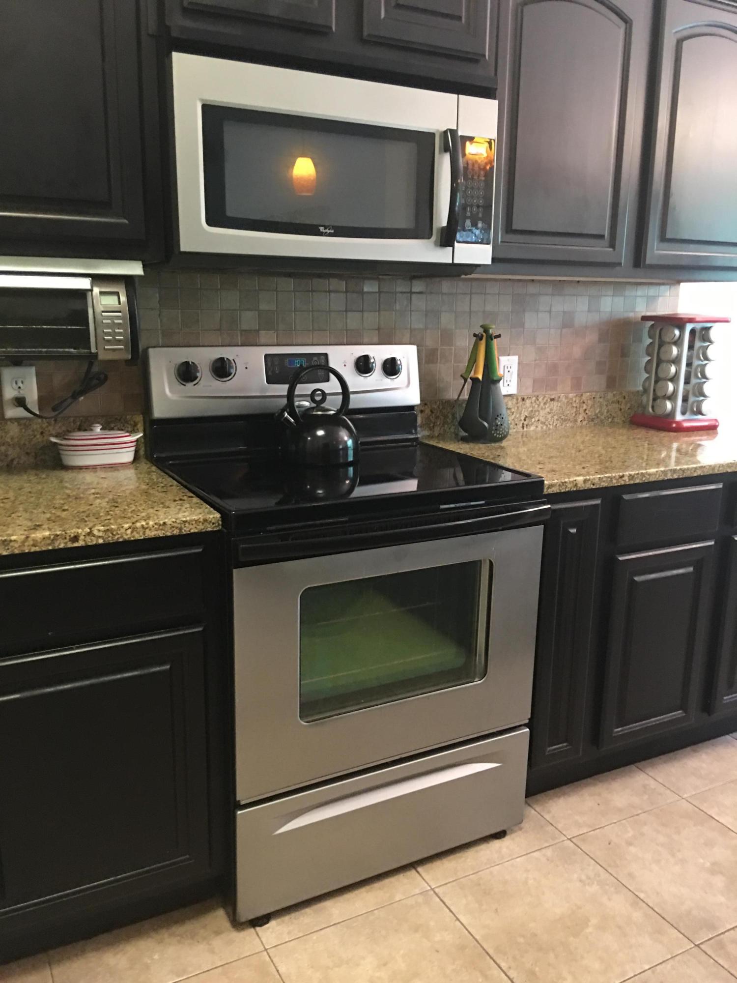 4568 Hermosa Road Crestview, FL 32539 - Photo 12 of 51 a kitchen with stainless steel appliances granite countertop a stove microwave and sink