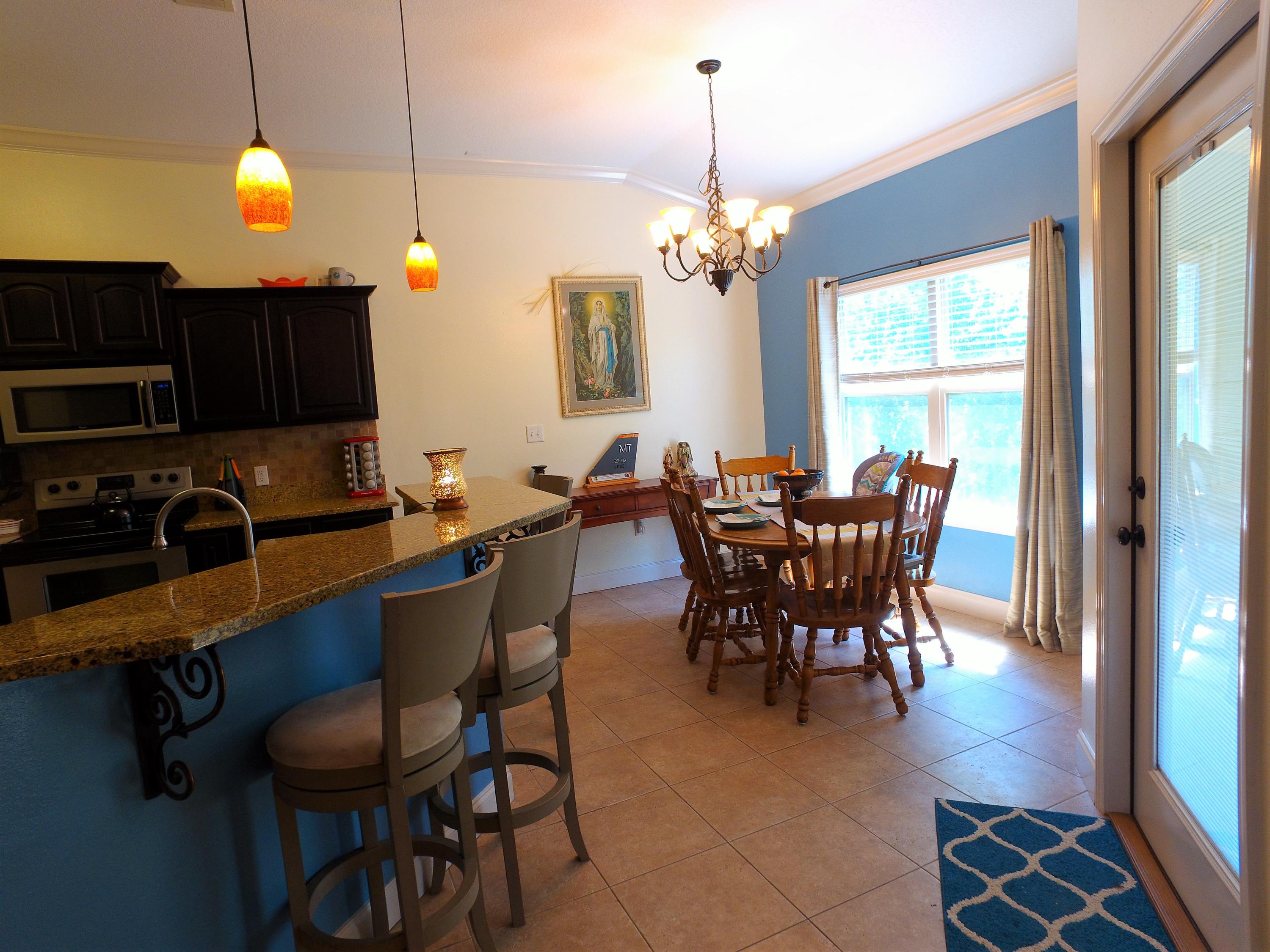 4568 Hermosa Road Crestview, FL 32539 - Photo 15 of 51 a view of a dining room with furniture window and outside view
