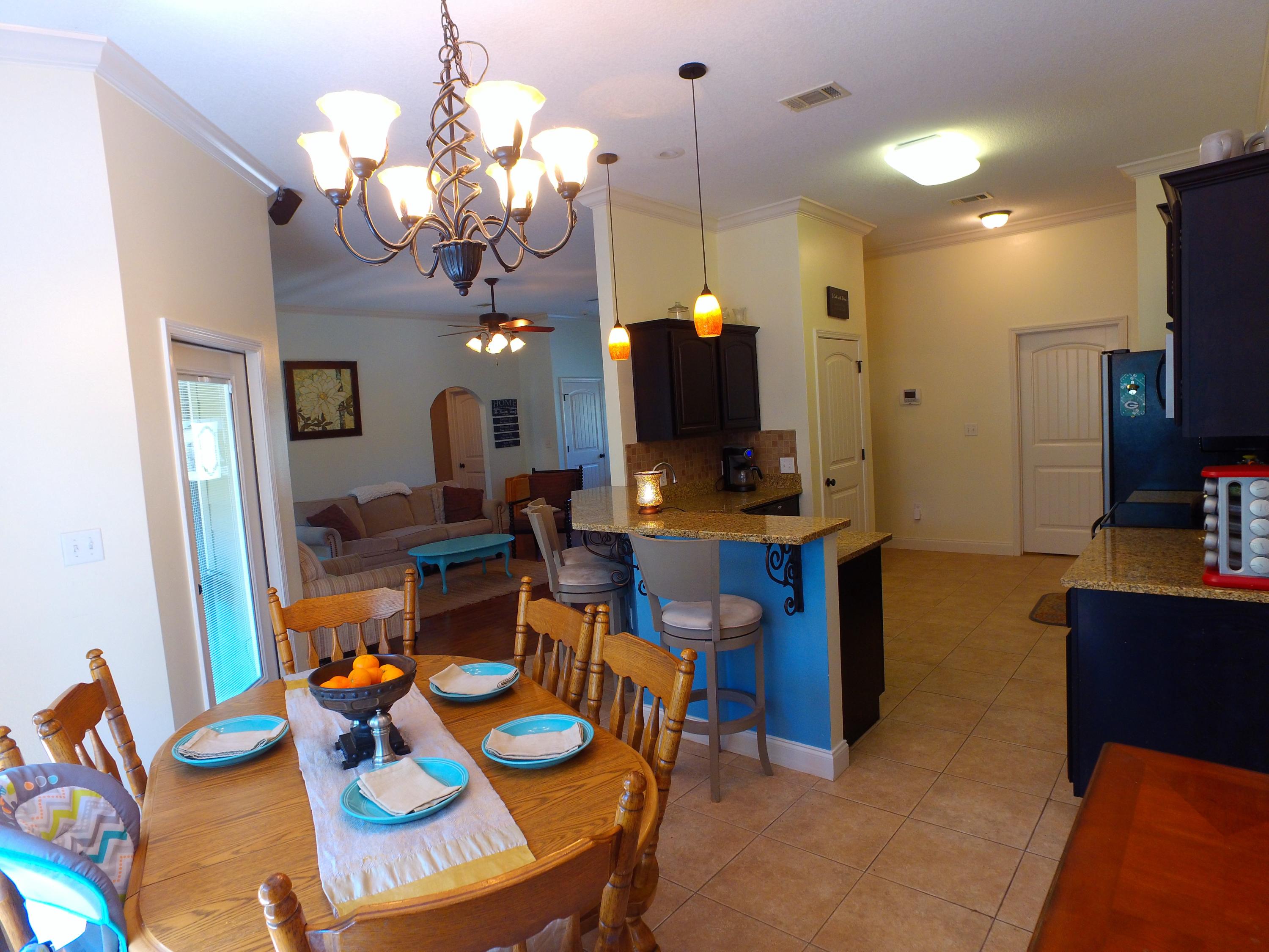 4568 Hermosa Road Crestview, FL 32539 - Photo 16 of 51 a view of a dining room with furniture and a chandelier