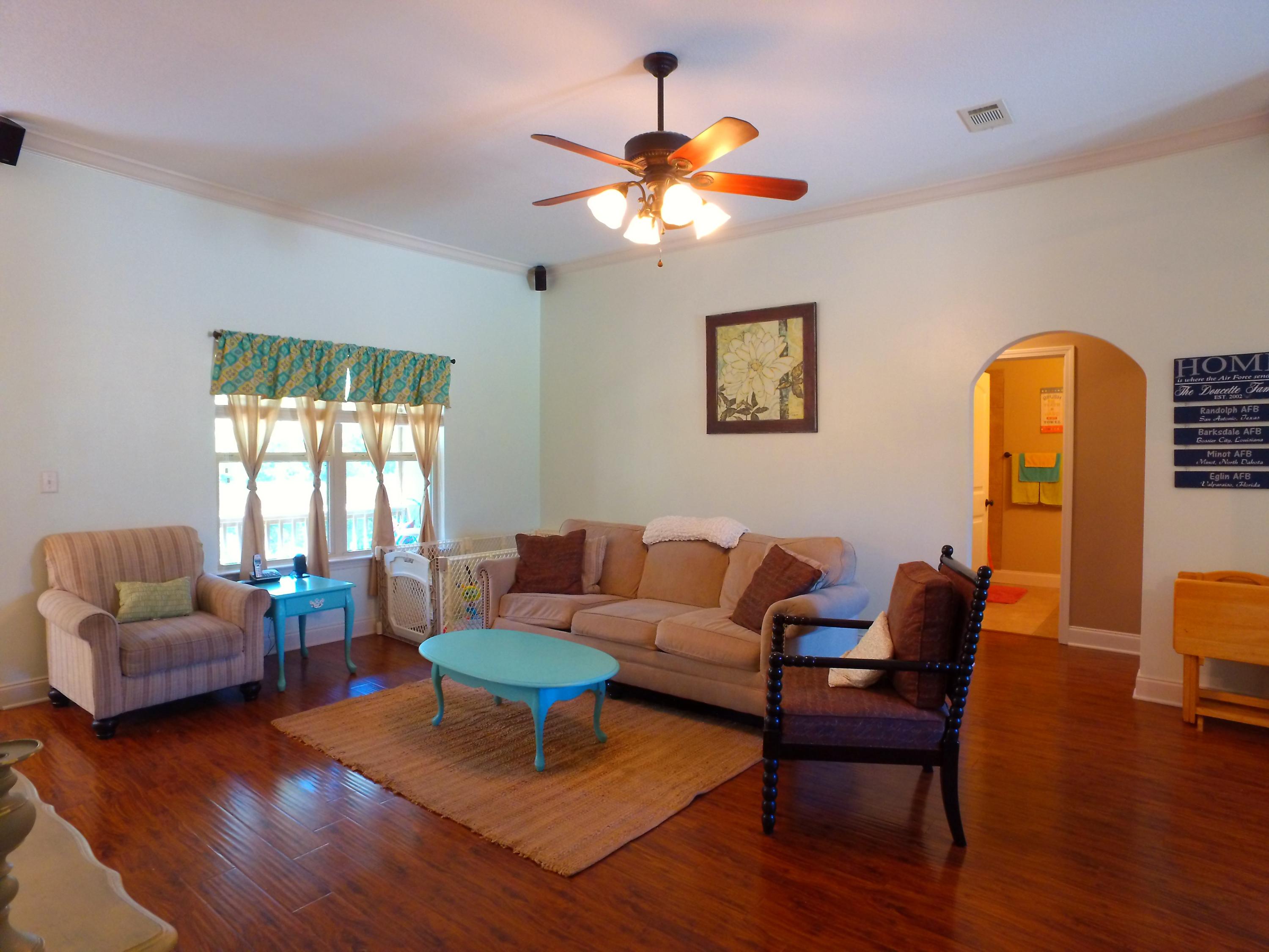 4568 Hermosa Road Crestview, FL 32539 - Photo 3 of 51 a living room with furniture and a chandelier