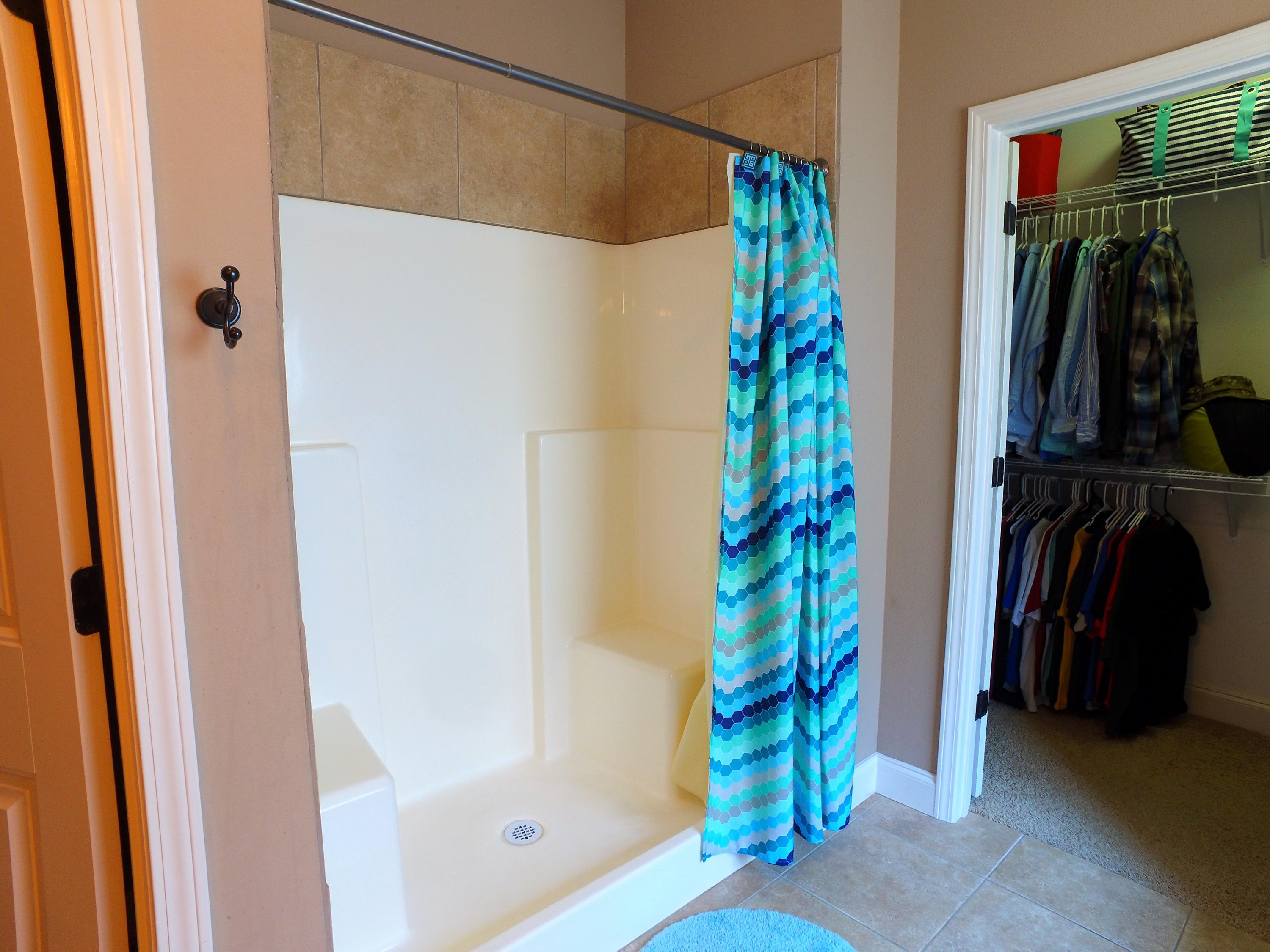 4568 Hermosa Road Crestview, FL 32539 - Photo 22 of 51 a view of walk in closet with clothes and shoes