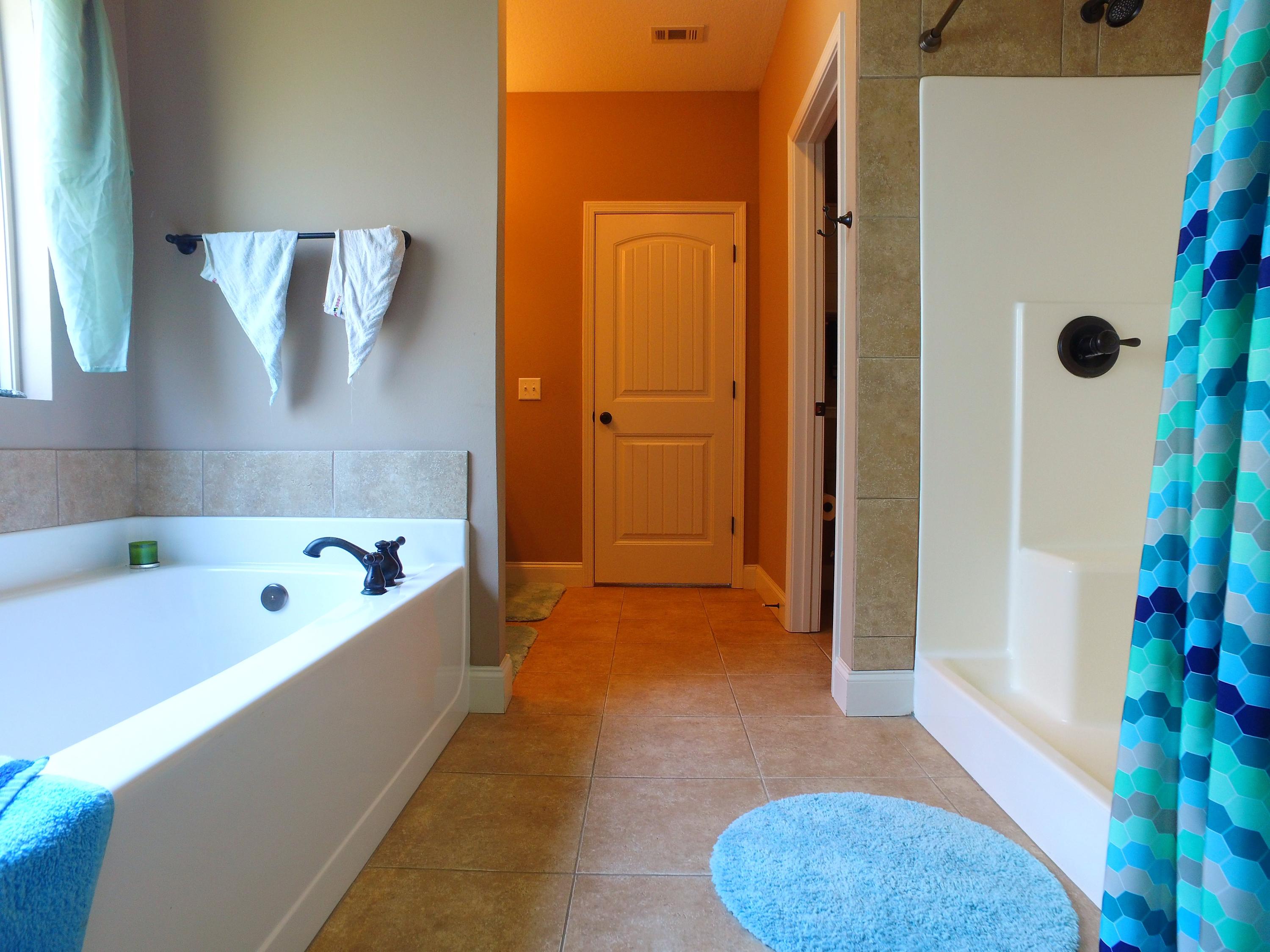 4568 Hermosa Road Crestview, FL 32539 - Photo 23 of 51 a bathroom with a tub a rug and a shower