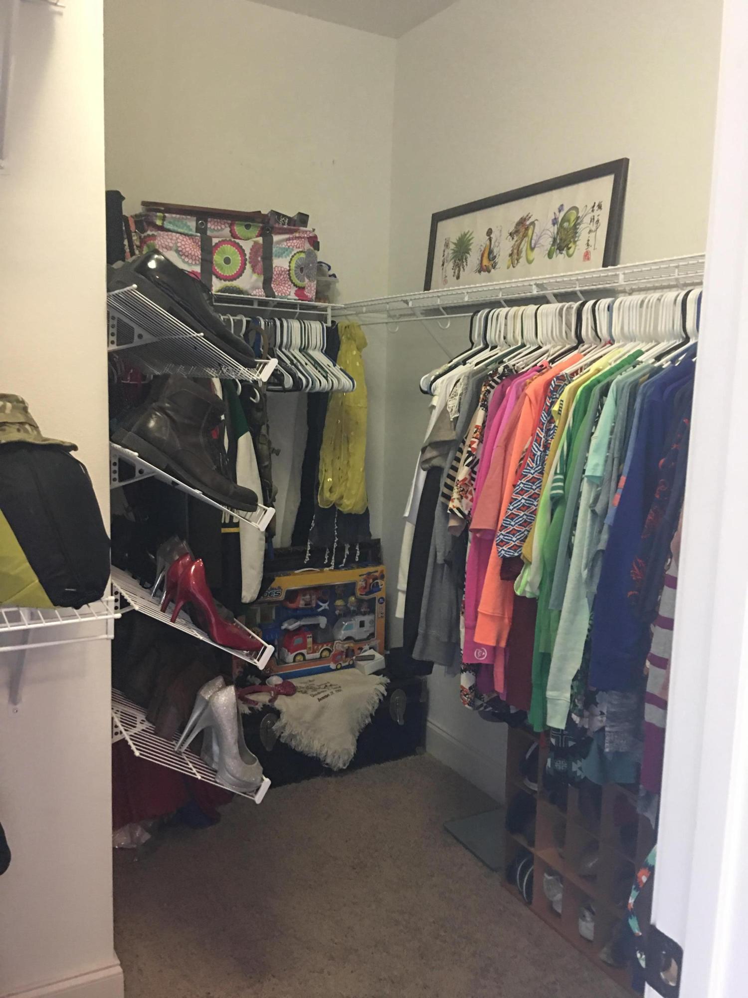 4568 Hermosa Road Crestview, FL 32539 - Photo 24 of 51 a view of walk in closet with clothes and shoes