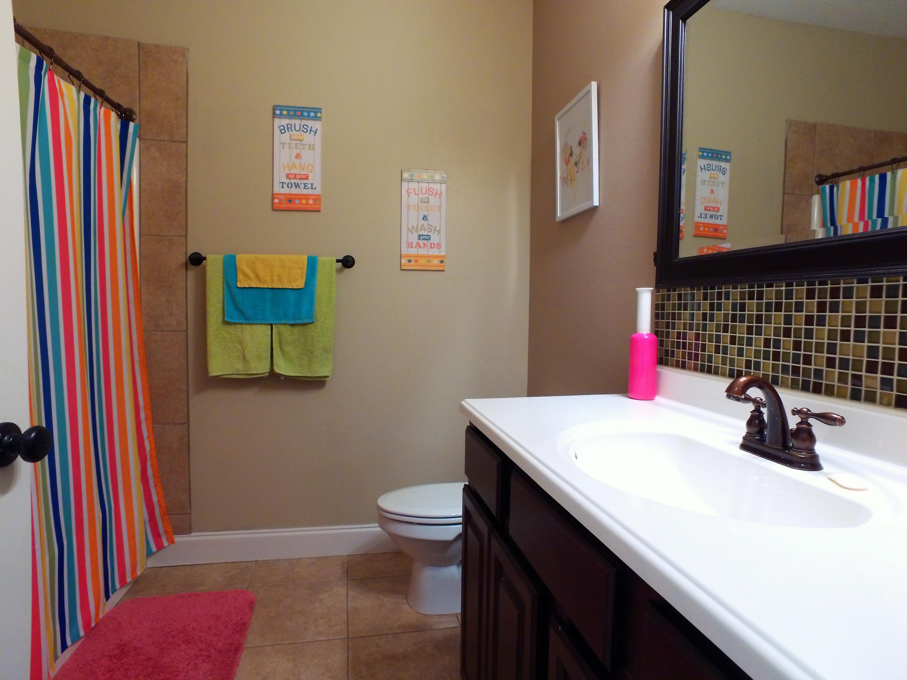 4568 Hermosa Road Crestview, FL 32539 - Photo 28 of 51 a bathroom with a sink a toilet and shower curtain