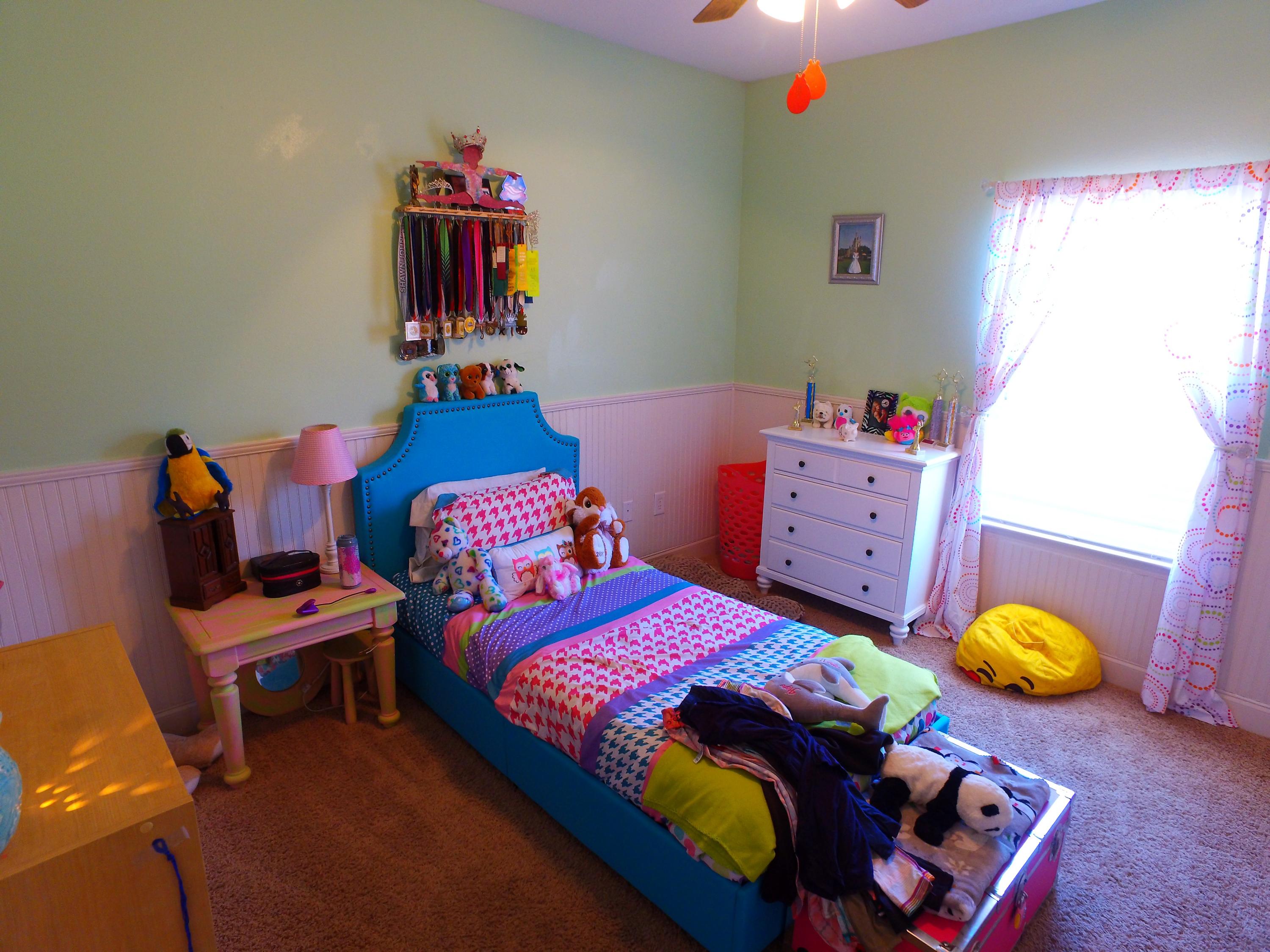 4568 Hermosa Road Crestview, FL 32539 - Photo 29 of 51 a bedroom with a bed and a chandelier