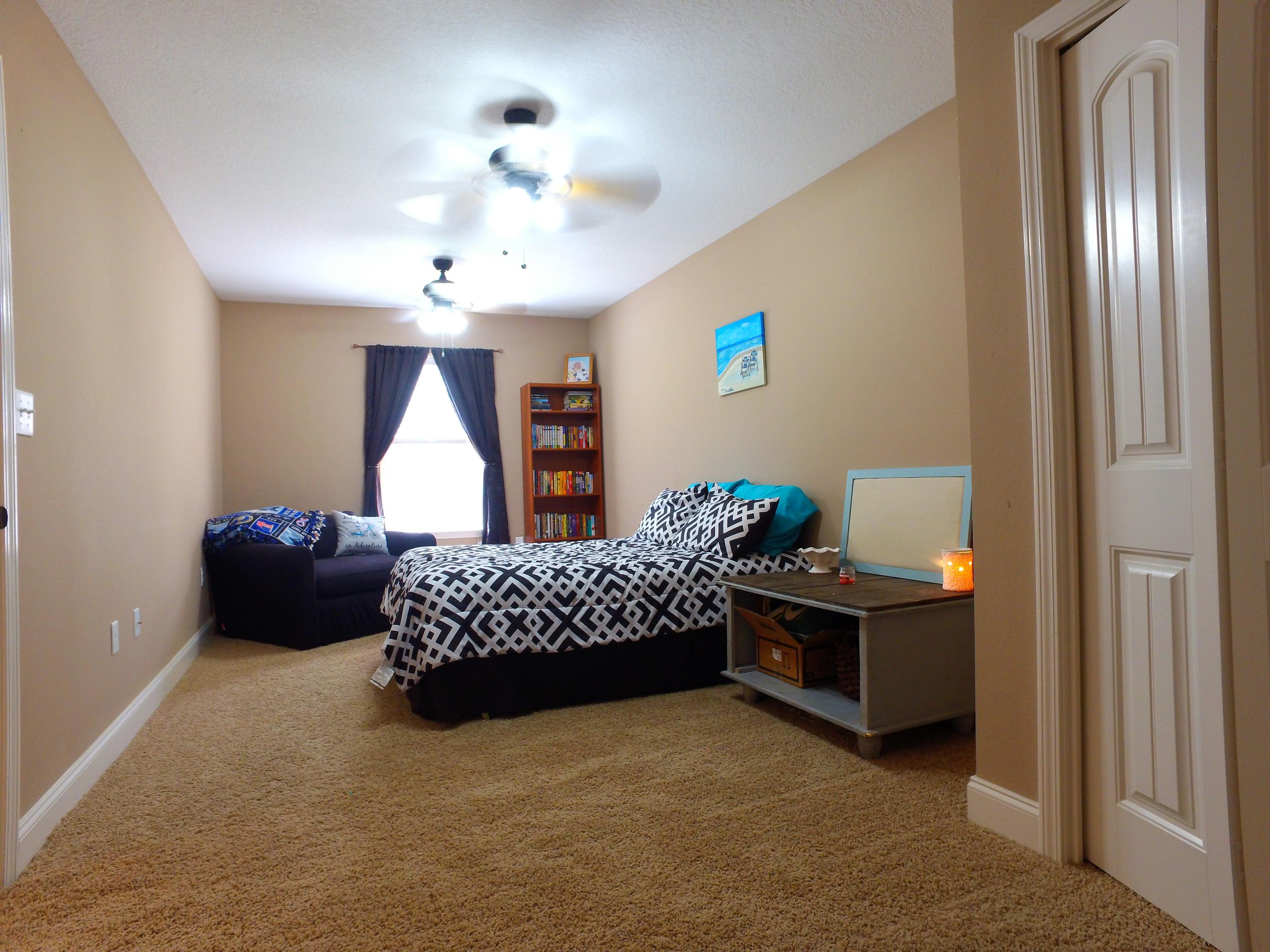 4568 Hermosa Road Crestview, FL 32539 - Photo 35 of 51 a living room with furniture and a chandelier