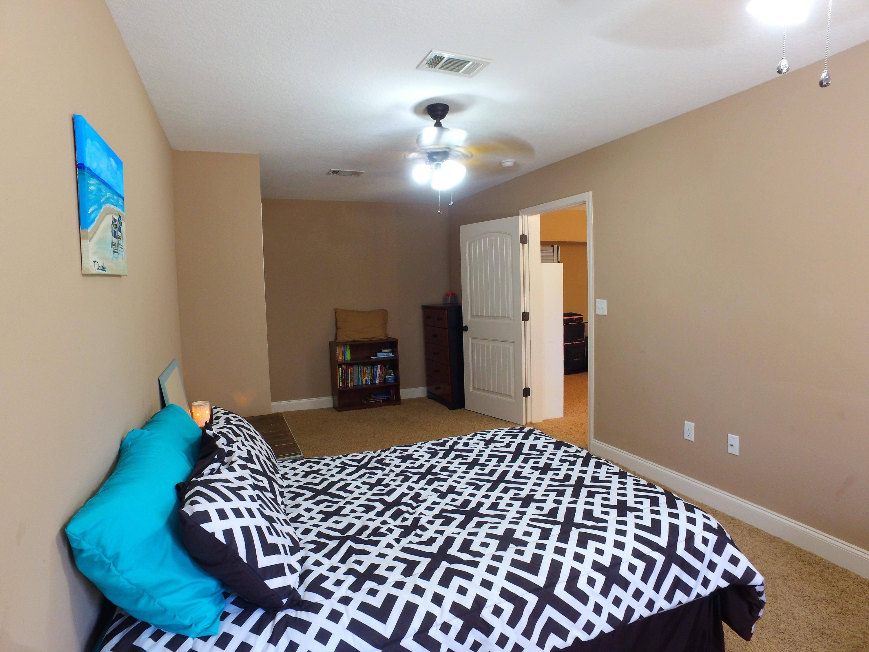 4568 Hermosa Road Crestview, FL 32539 - Photo 36 of 51 a bedroom with a bed and wooden floor