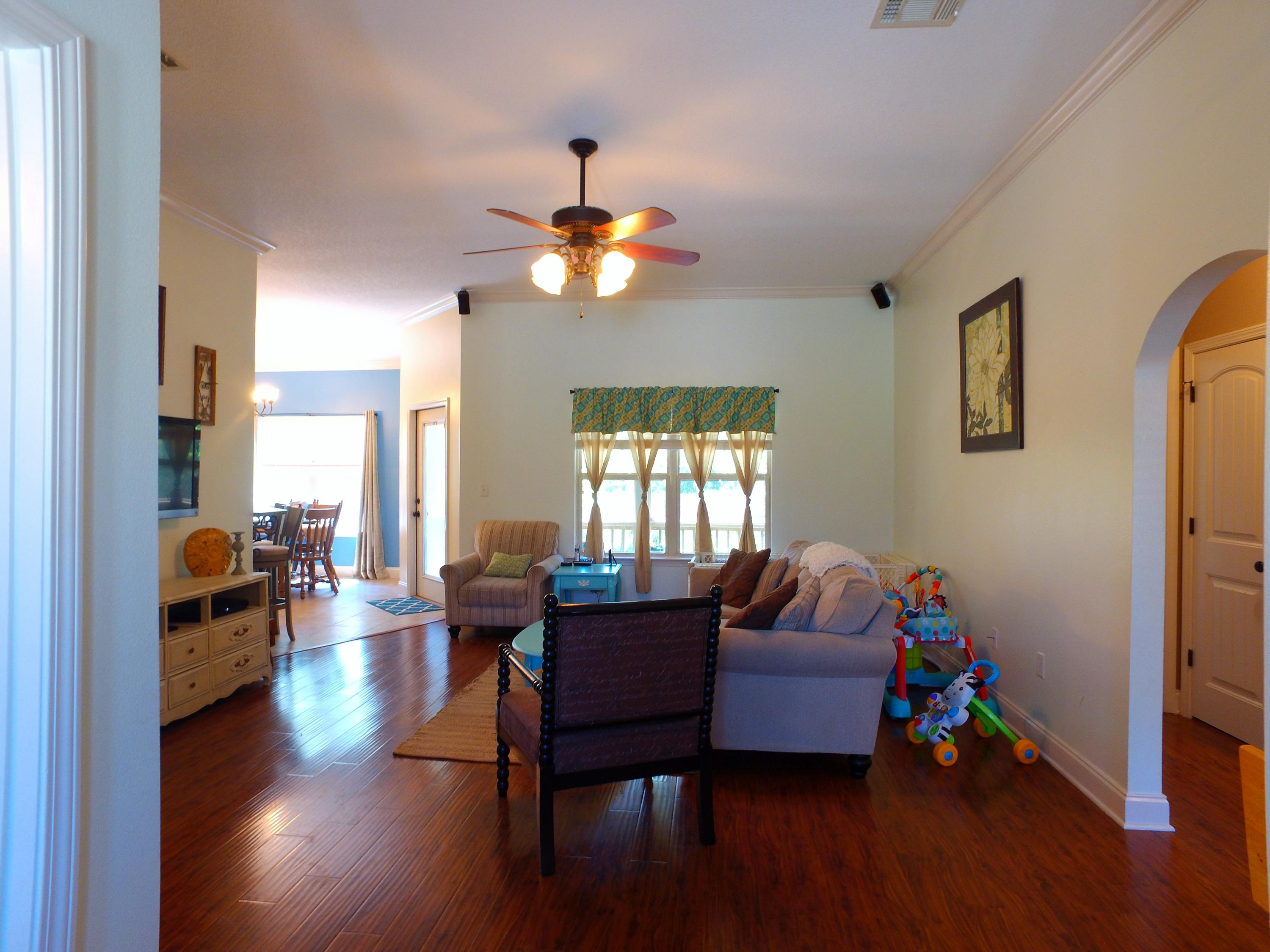4568 Hermosa Road Crestview, FL 32539 - Photo 5 of 51 a living room with furniture and wooden floor