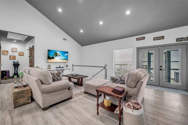 a living room with furniture and a wooden floor