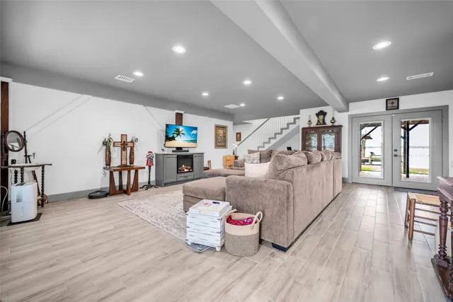 a living room with furniture and wooden floor