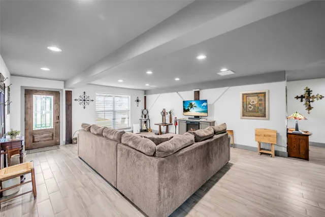 a living room with furniture and a wooden floor