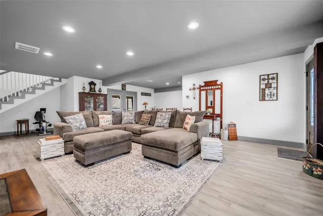 a living room with furniture and a wooden floor