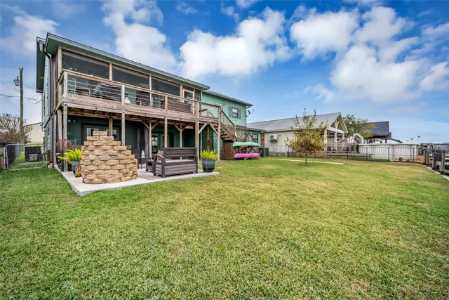 a view of a house with a big yard and sitting area