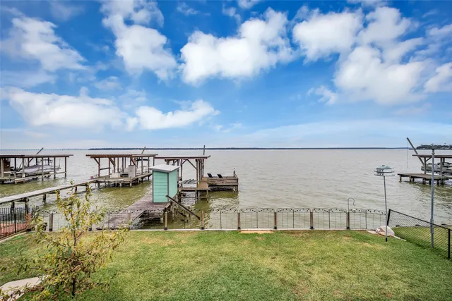 a view of a lake with lawn chairs