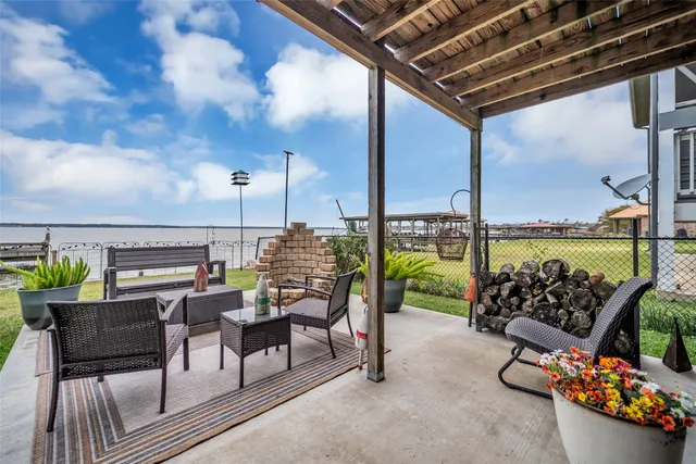 a roof deck with table and chairs