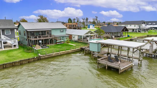 an aerial view of a house with swimming pool and a yard