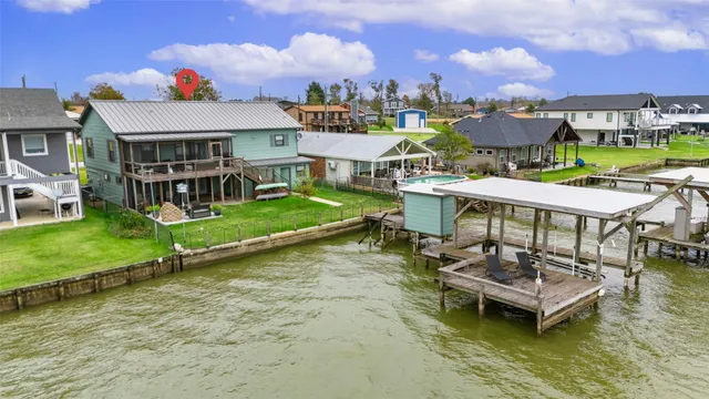an aerial view of a house with swimming pool and a yard