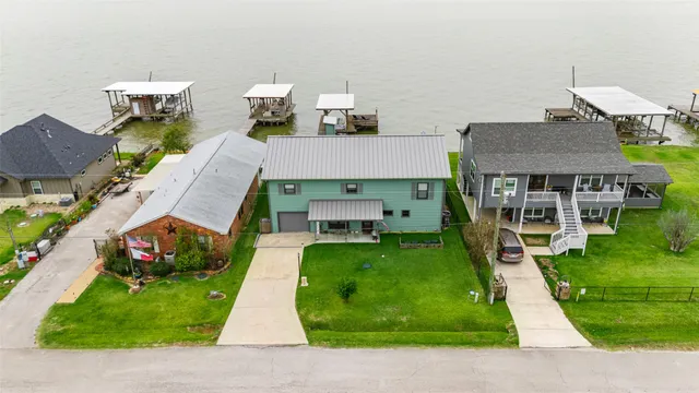 an aerial view of a house with swimming pool garden and patio