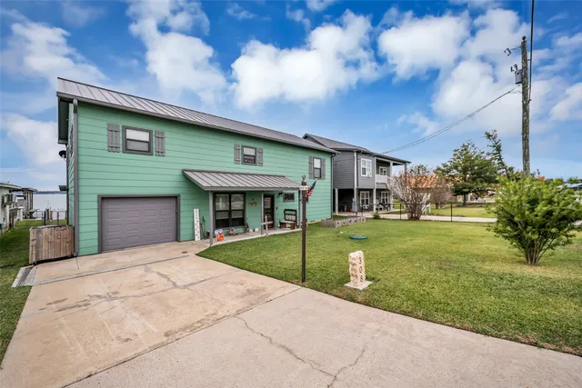 a front view of house with yard and green space