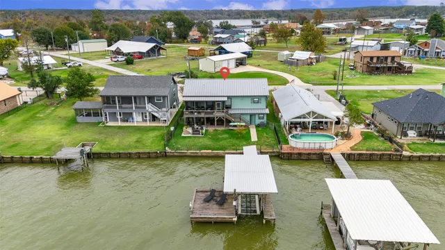 an aerial view of a house with swimming pool garden and outdoor seating