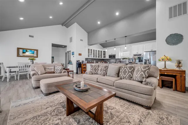 a living room with furniture and kitchen view