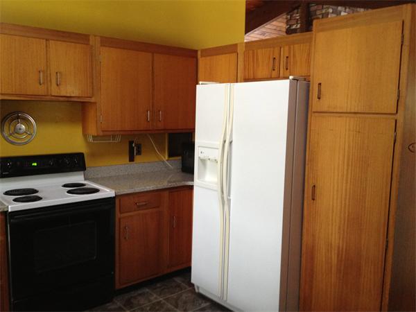 68 Sedgemeadow Road Wayland, MA 01778 - Photo 5 of 17 a white refrigerator freezer and a stove sitting inside of a kitchen