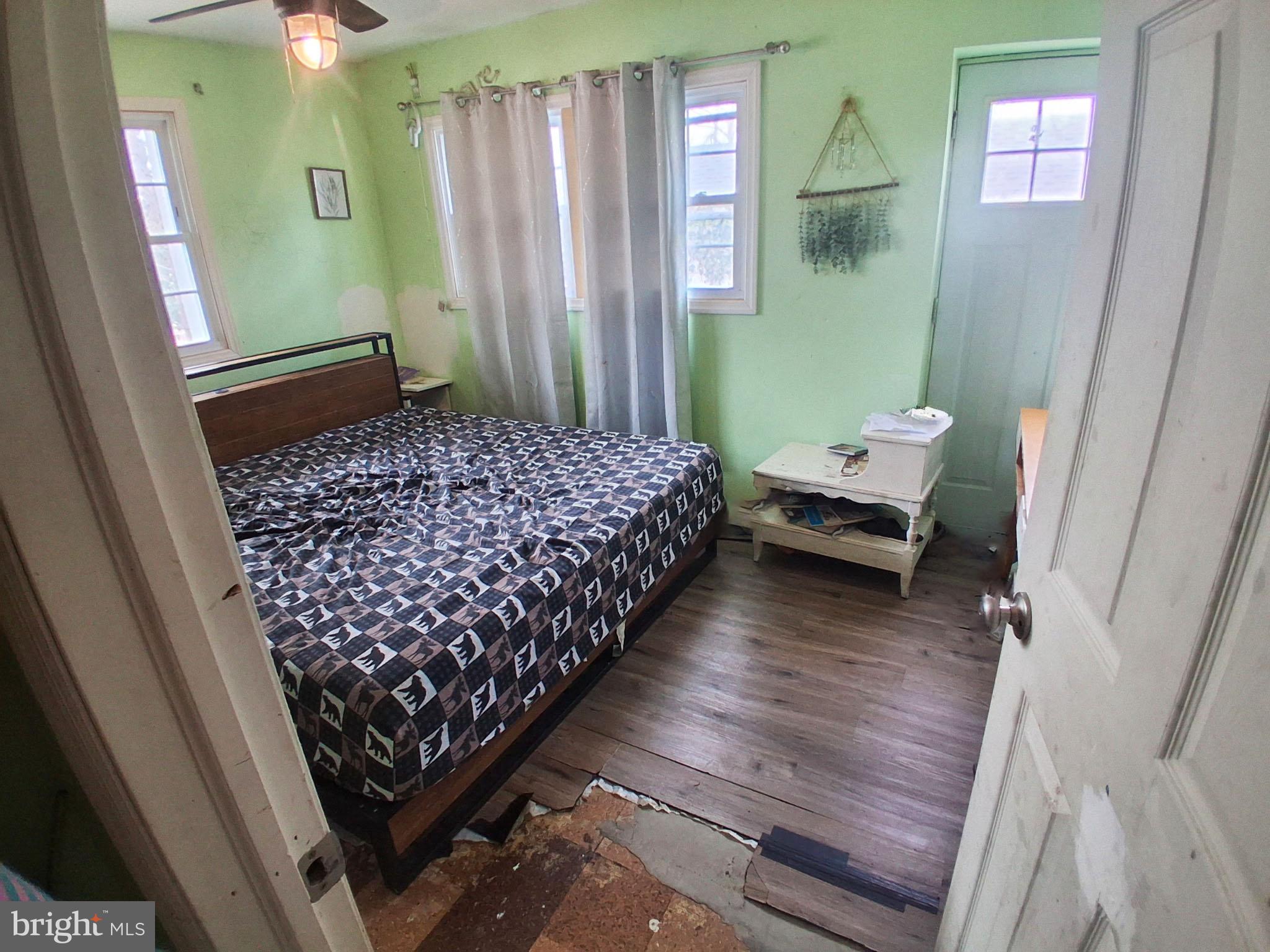 1018 West Browning Road Bellmawr, NJ 08031 - Photo 5 of 15 a bedroom with wooden floor and furniture
