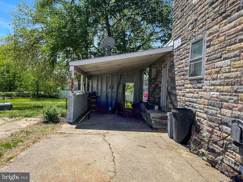1018 West Browning Road Bellmawr, NJ 08031 - Photo 9 of 15 a view of a patio with table and chairs potted plants and a large tree