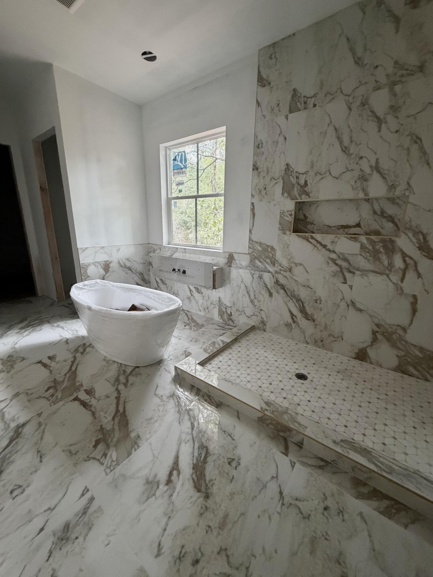 219 South J Hunter's Way, Unit LOT 73 Freeport, FL 32439 - Photo 6 of 10 a bathroom with a sink toilet and shower