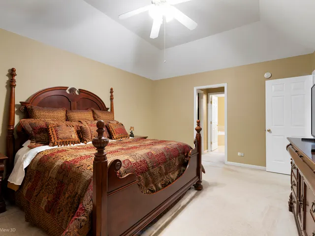 a bedroom with two beds and a chandelier