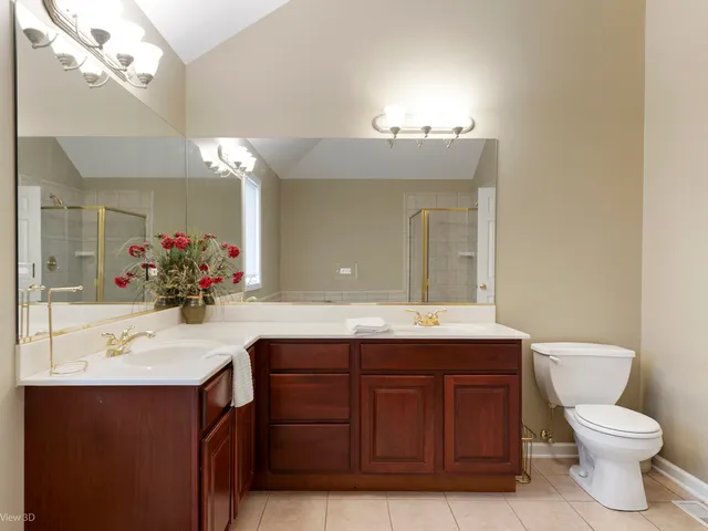 a bathroom with a sink vanity mirror and toilet