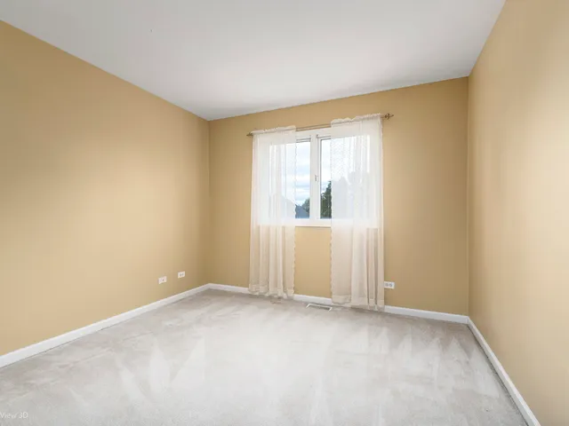 an empty room with a empty space and windows