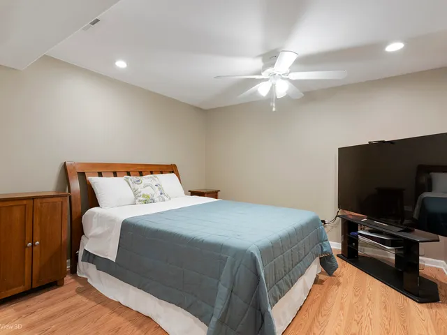 a bedroom with a bed and a flat screen tv