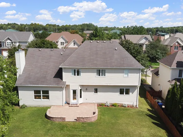 a aerial view of a house with table and chairs