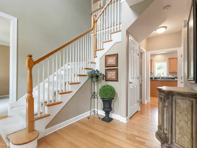 a view of entryway and hall with wooden floor