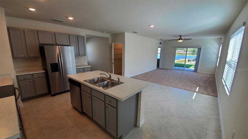 140 Old Mill Edgewater, FL 32141 - Photo 2 of 12 a kitchen with stainless steel appliances a stove a refrigerator a sink and a refrigerator