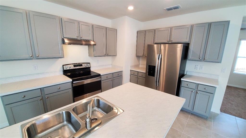 140 Old Mill Edgewater, FL 32141 - Photo 3 of 12 a kitchen with a refrigerator sink and stove