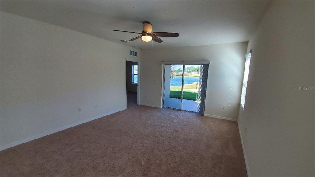 140 Old Mill Edgewater, FL 32141 - Photo 4 of 12 an empty room with windows and fan