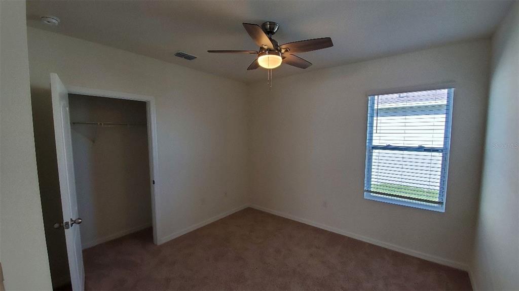 140 Old Mill Edgewater, FL 32141 - Photo 8 of 12 an empty room with closet and windows