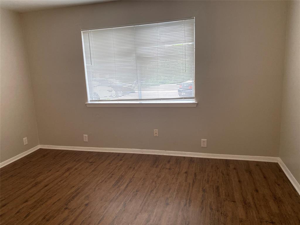 4606 Monarch Street, Unit 104 Dallas, TX 75204 - Photo 8 of 13 Unfurnished room with plenty of natural light and dark wood-type flooring