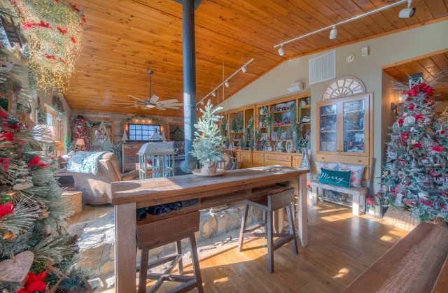 a bedroom with a bed a mirror on dresser and a large window