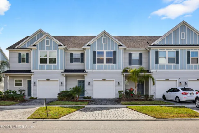 a view of a white house with couches in front of it
