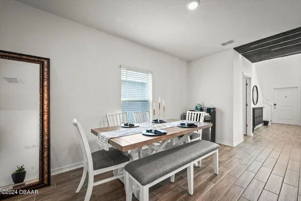 a view of a dining room with furniture and wooden floor