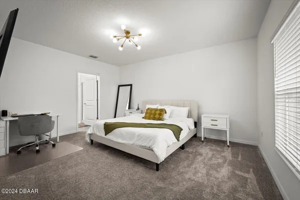 a bedroom with a bed and a chair