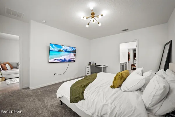 a bedroom with a bed and a chandelier
