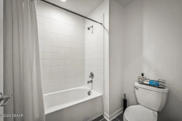 a bathroom with a toilet and a bathtub