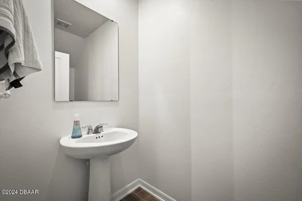 a bathroom with a sink and mirror