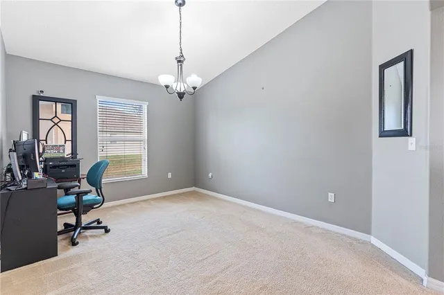 a view of a livingroom with a window and workspace